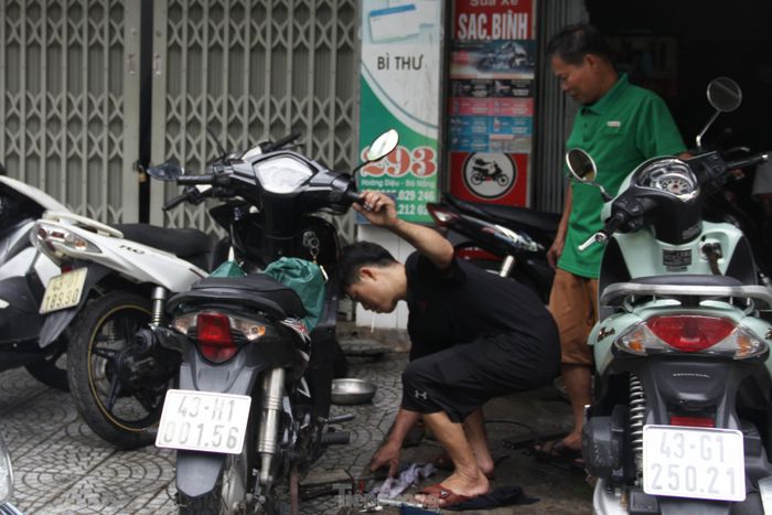 Dòng xe máy bị ngập nước qua đêm, các thợ sửa xe ở Đà Nẵng bận rộn từ buổi sáng - Ảnh 9.