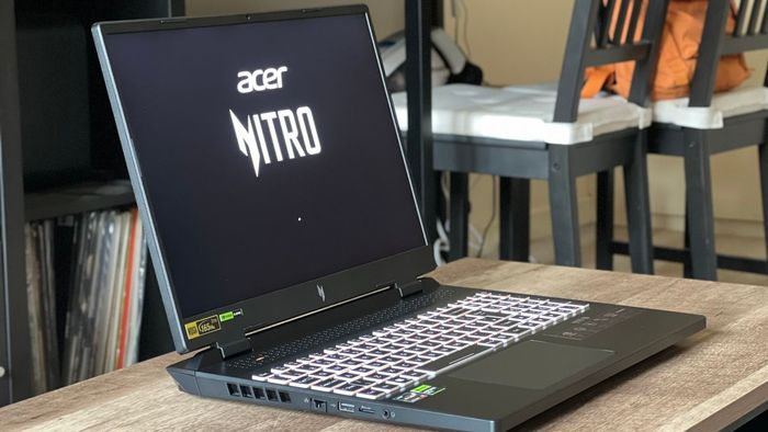 Laptop chơi game Acer Nitro 16 mở trên bàn gỗ
