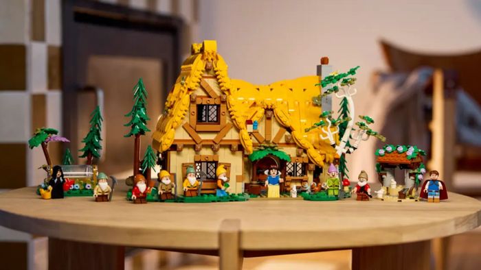Một ngôi nhà Lego và các nhân vật nhỏ từ Snow White and the Seven Dwarfs trên một bàn gỗ