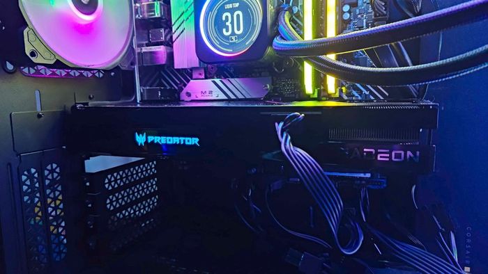 Card đồ họa AMD Radeon RX 7600 bên trong PC cạnh quạt RGB và tản nhiệt nước AIO