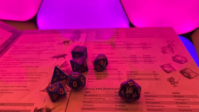 Một bộ xúc xắc D&D trên màn hình của Dungeon Master với Nanoleaf Shapes trong nền