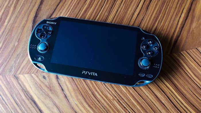 Máy PlayStation Vita trên bàn gỗ