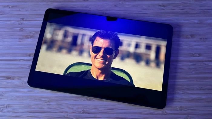 Máy tính bảng Amazon Fire Max 11 chạy một bộ phim trên một bàn gỗ