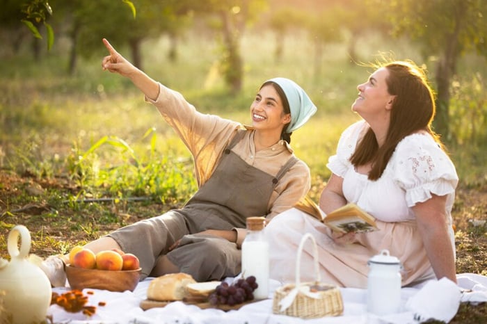 Two women are having a picnic in the park