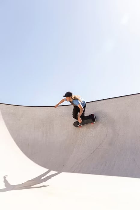 She is skateboarding in a skate park