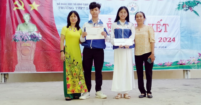 Gia Huy và mẹ (bên trái) nhận phần thưởng trong lễ tổng kết năm học 2023-2024.