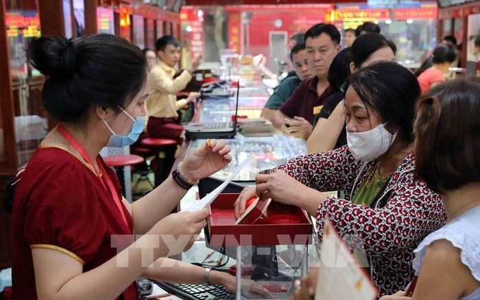Khách hàng mua bán vàng tại Công ty Vàng bạc Bảo Tín Minh Châu, đường Trần Nhân Tông, Hà Nội. Hình ảnh: Trần Việt - TTXVN