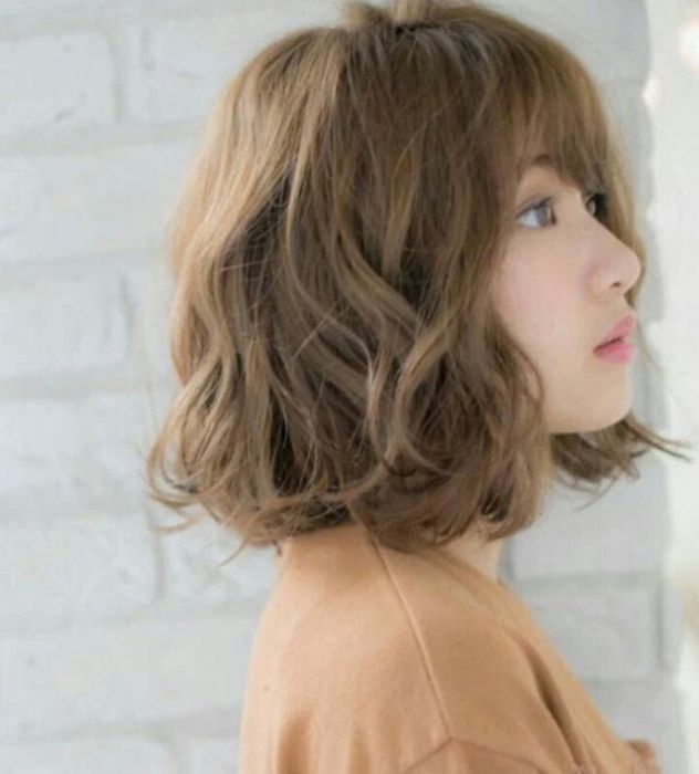 Tóc ngắn xoăn nhuộm màu nâu.