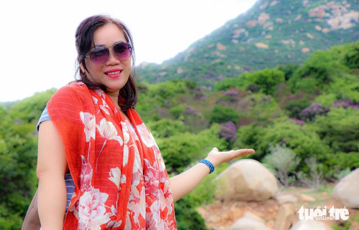 Chị Hiền Dung tạo dáng bên những chùm hoa bằng lăng nở rộ - Ảnh: DUY NGỌC