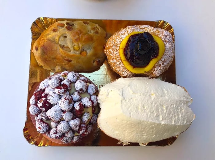 A maritozzo, pictured here at the bottom right from a Roman bakery, is a sweet, yeasty roll generously filled with whipped cream.