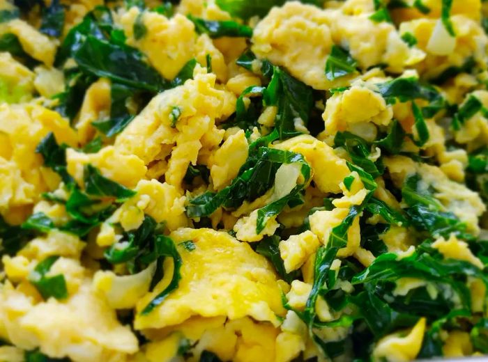 Scrambled eggs served with sautéed chaya.