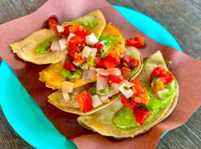 Tacos topped with a fresh vegetable salsa.