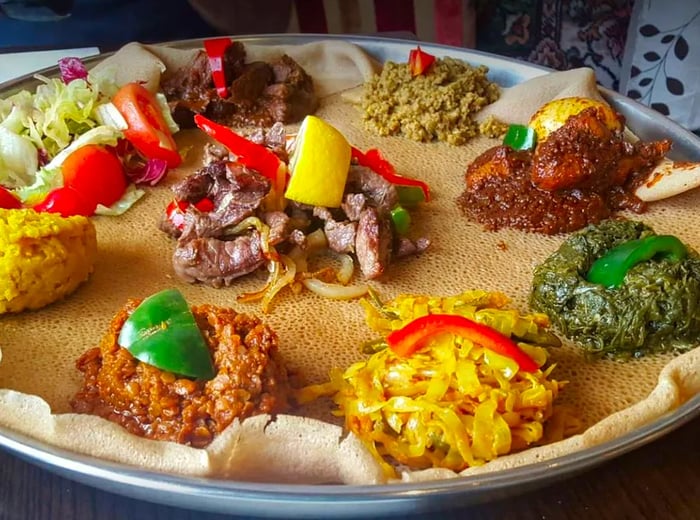 A vibrant spread of injera accompanied by an array of colorful dips.