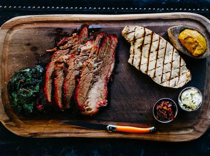 <div>
                
                  <div>A wooden platter filled with an assortment of grilled meats viewed from above.</div>
                </div>