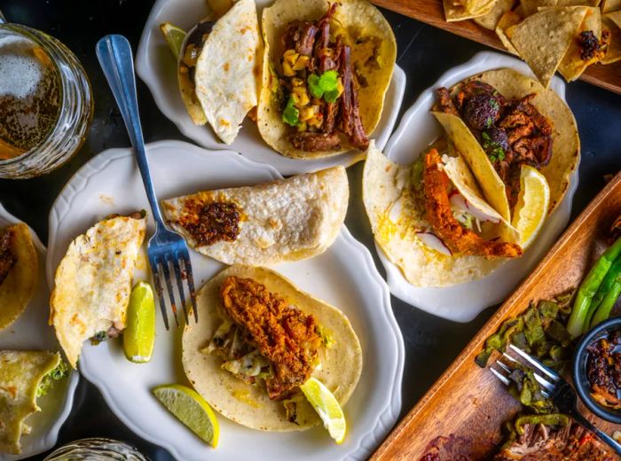 <div>
                
                  <div>An aerial view of a table laden with various taco plates.</div>
                </div>