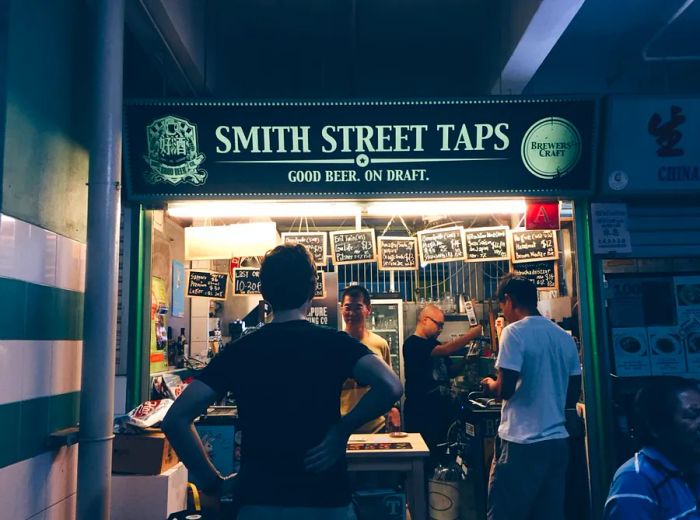 A patron stands in front of the Smith Street Taps stall, ready to explore its offerings.