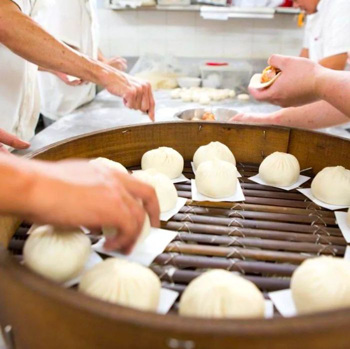 Workers grilling bao buns.