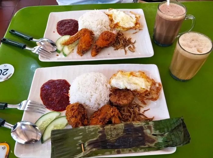 A variety of nasi lemak trays featuring a mix of fried items.