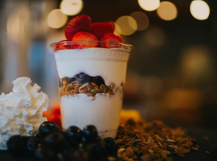 Frozen yogurt topped with fresh strawberries and blueberries