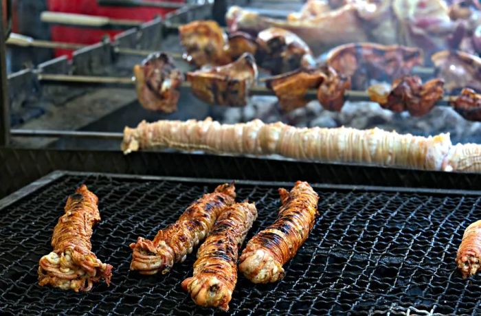 Grilled coils of lamb offal on a metal grill