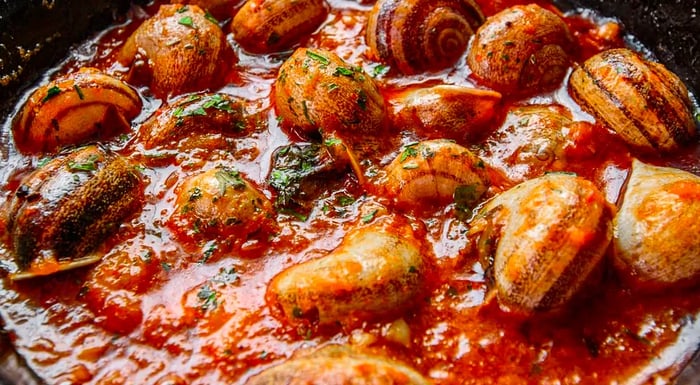 Snails, still in their shells, cooked in a rich, tangy tomato sauce