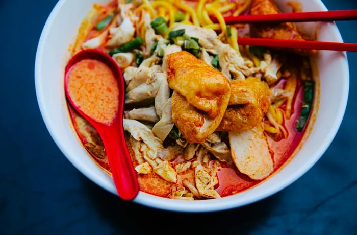 Spicy red broth with noodles in a classic laksa