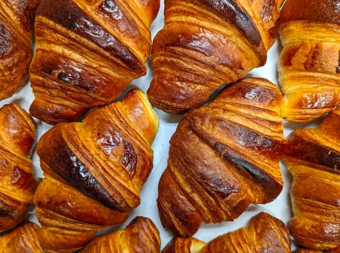 An overhead view of a selection of freshly baked croissants.