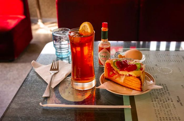 An iced tea paired with a slice of pizza toast at Yashiro