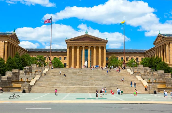 A grand art museum building with steps leading up to its impressive colonnaded entrance