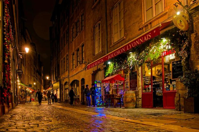 Evening on Rue Saint-Jean, a renowned street in Lyon famous for its many bouchons lyonnais, traditional eateries of the city.