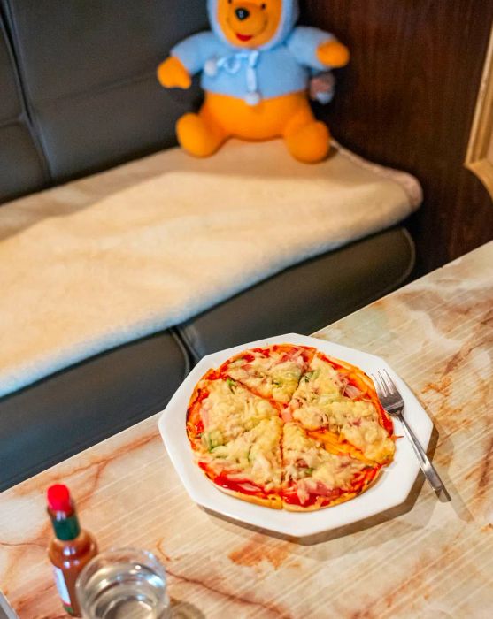 A round pizza, sliced and served on a table