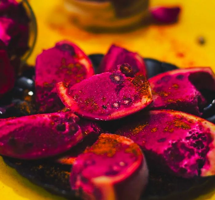 A heap of vibrant pomegranate kulfi, elegantly packed into hollowed pomegranate skins.