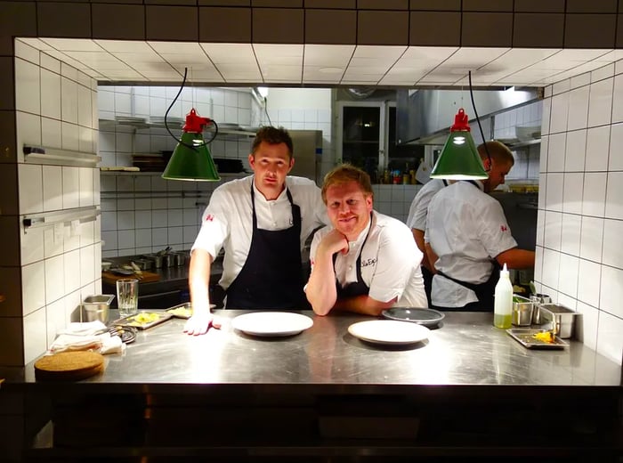 Two chefs, Tom Sjöstedt and Daniel Räms, gaze out from the restaurant kitchen.