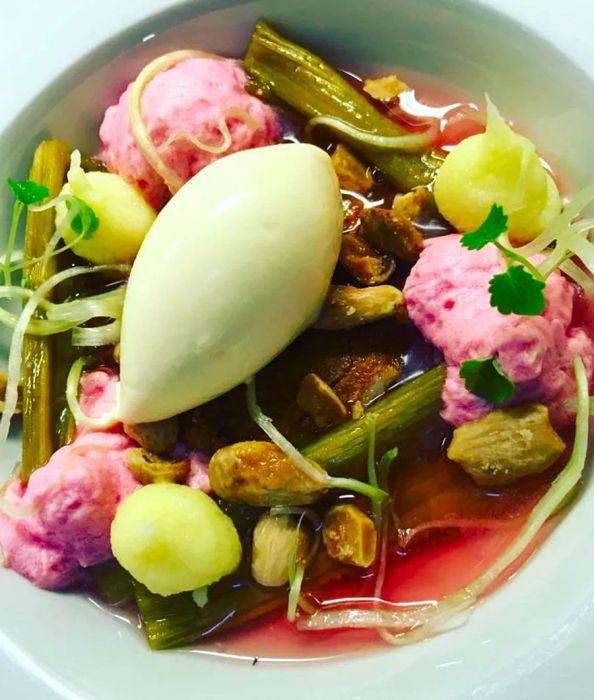 A close-up view of a blend of rhubarb, flowers, and mousse.