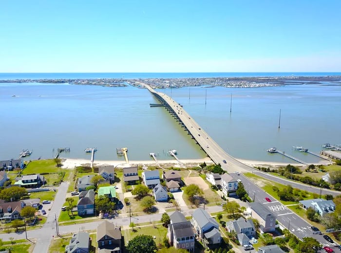 A picturesque view from a small city across a bridge and waterway towards the islands