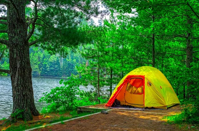 a tent overlooking a serene lake.