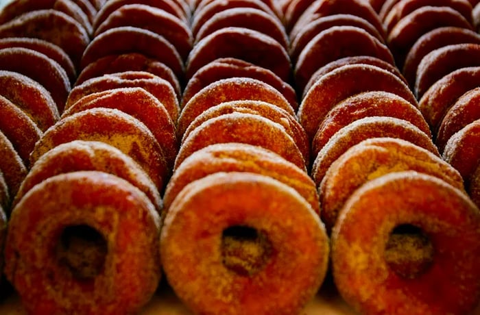 A tempting display of cider donuts dusted with sugar.