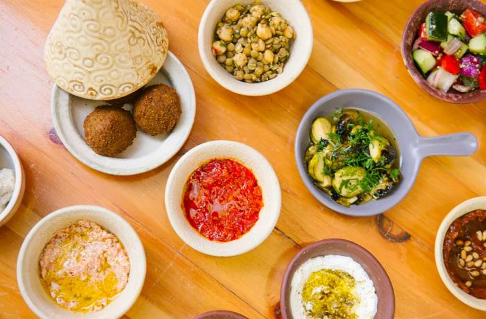 a variety of small dishes featuring different Israeli foods.