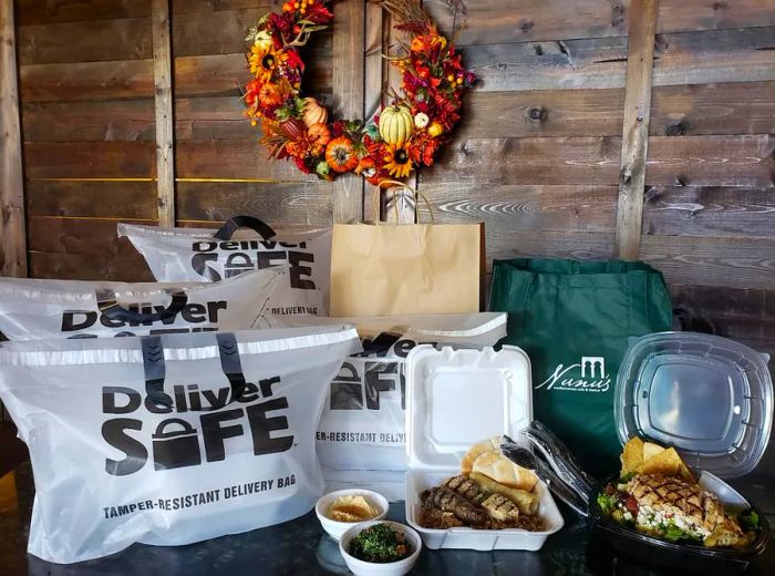 A table brimming with takeout containers and packaging