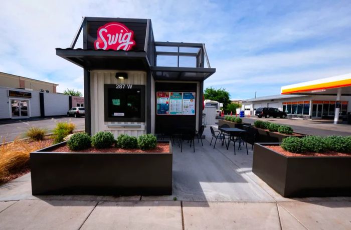 A Swig kiosk positioned outside a gas station.