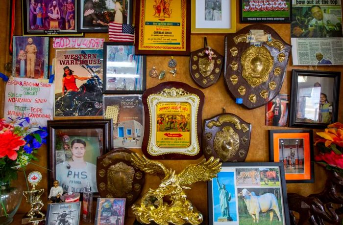 A collection of plaques, framed pictures, and assorted memorabilia adorning a wall.