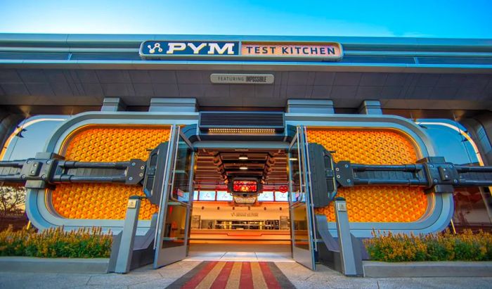 Futuristic yellow doors serve as the entrance to a high-tech dining establishment.