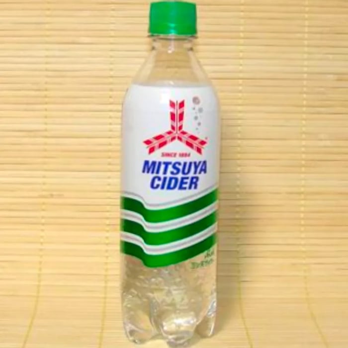 A transparent bottle featuring a green and white label.