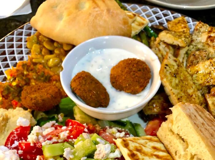 An elegantly arranged platter featuring small portions of various dishes.