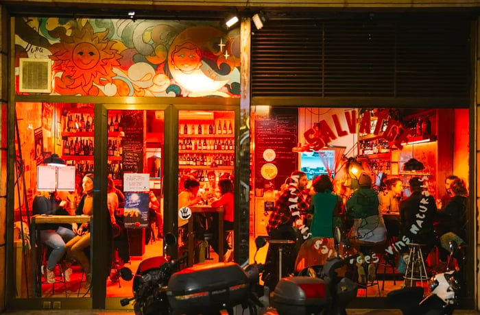 Peering into the window of a bustling wine bar.