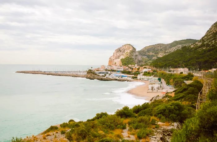 A rocky beach with distant boulders.