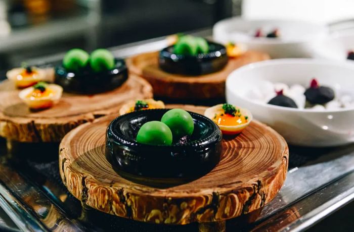 Spherified olives elegantly displayed on a wooden board