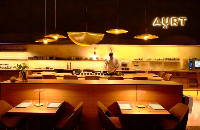 A softly illuminated chef's counter in the restaurant