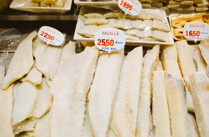 Strips of dried white fish resting on ice.