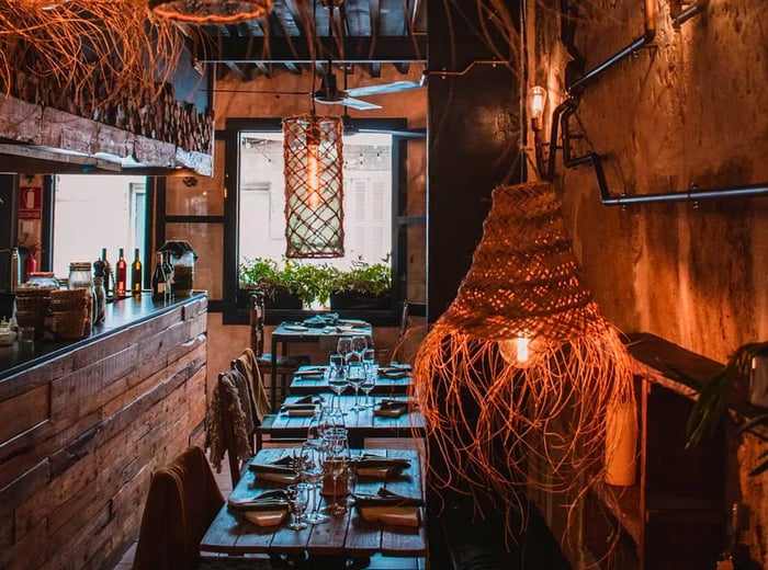 A dining area adorned with woven baskets, wood accents, and industrial lighting.